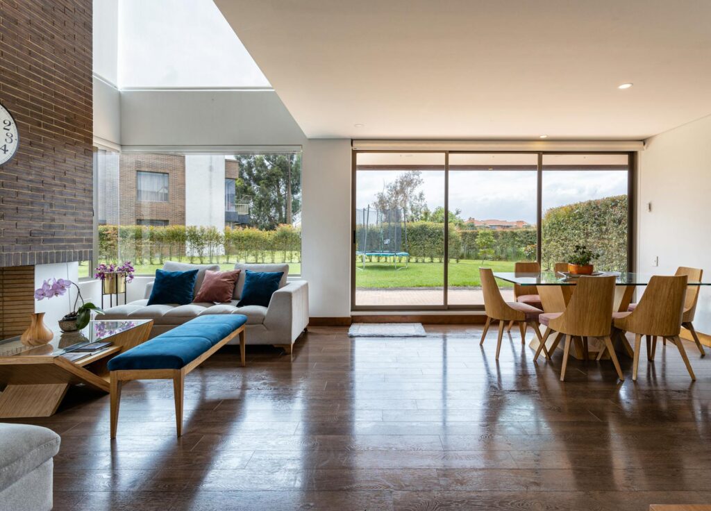 an interior of the living room and the dining area of a house