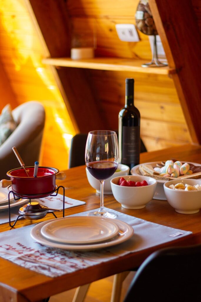 cozy indoor dining setup with fondue and wine